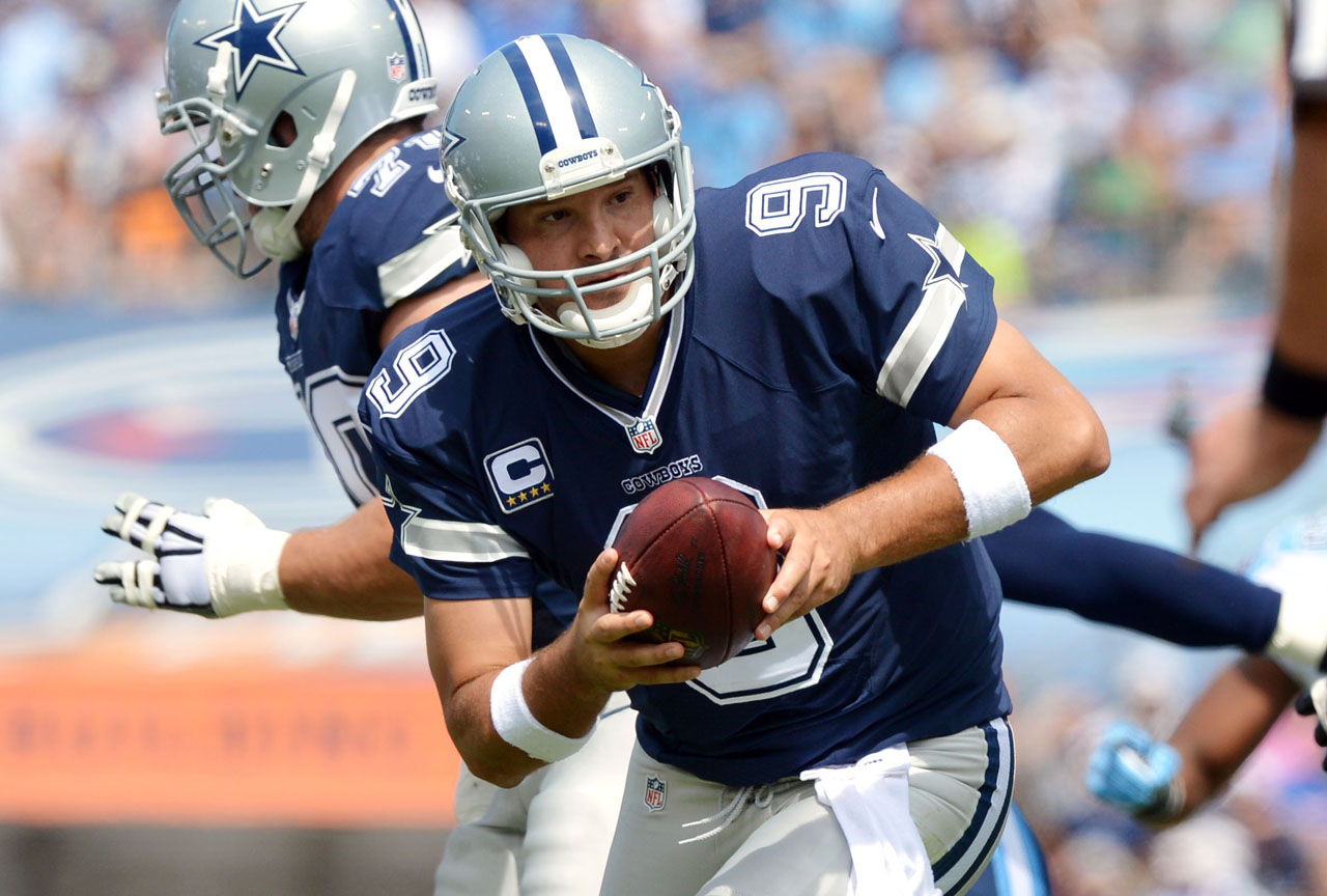 Dallas Cowboys Tony Romo runs out of the pocket in the first