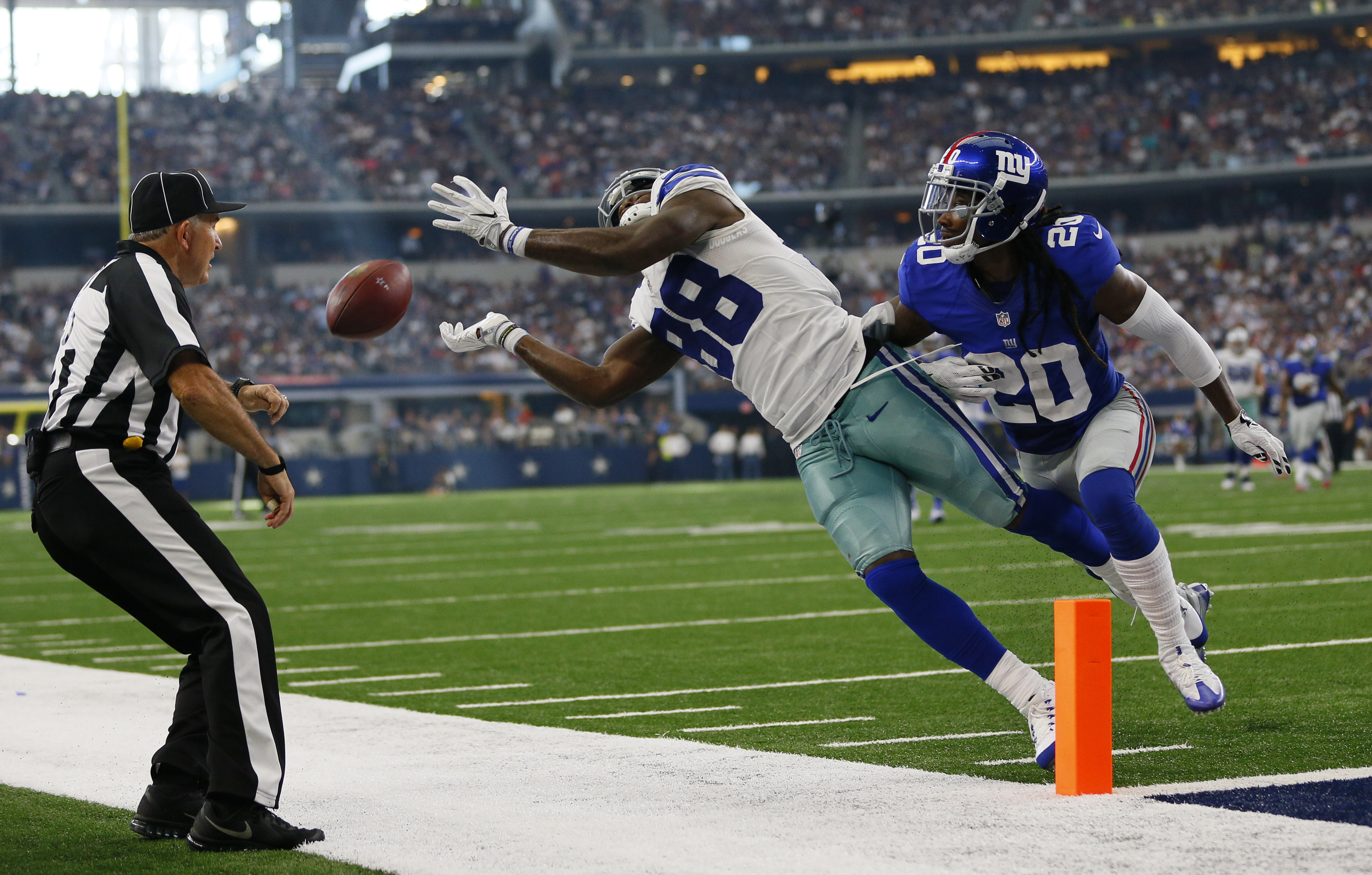 Dallas Cowboys wide receiver Dez Bryant (88) eludes Washington Redskins  defenders to take a Tony Romo pass for 85 yards and a touchdown in the  third quarter at Cowboys Stadium in Arlington