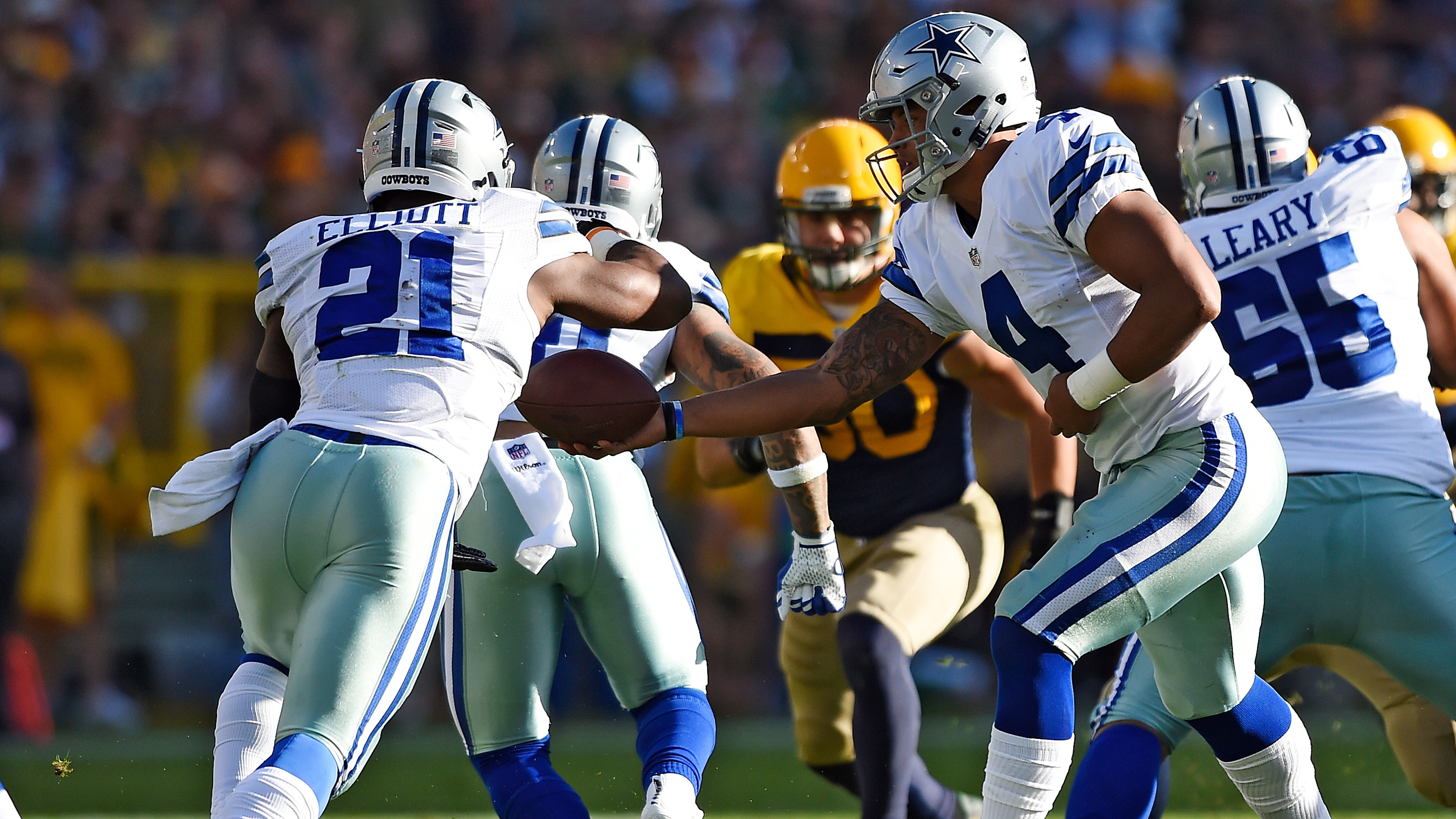 Cowboys roll to 30-16 win, record books in Green Bay