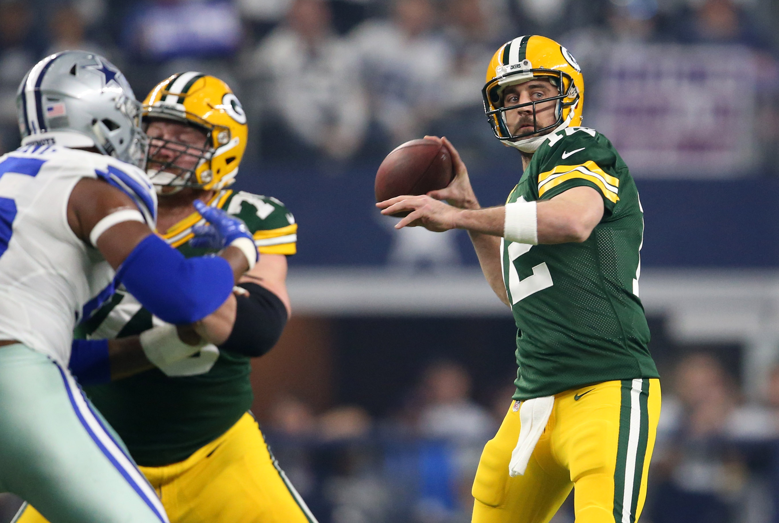 Green Bay Packers Aaron Rodgers looks to throw against the Dallas Cowboys  in the NFC divisional playoff game at AT&T Stadium in Arlington, Texas on  January 15, 2017. Rodgers went 28 of